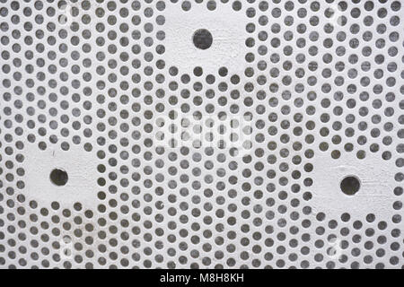 Plastic background with circles, white tone, great for design. Texture with perforation of round holes. White plate with dots Stock Photo