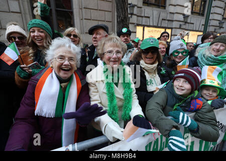 Revellers watching the St Patrick's Day parade on 5th Avenue in New York City. Stock Photo