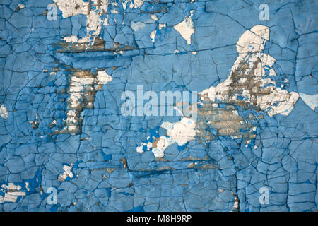 Old, blue, exfoliated, peeling paint on the concrete wall. The background Texture Stock Photo