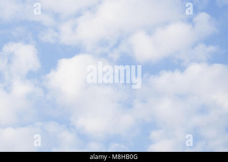 White heap clouds and bright sun in the blue sky Stock Photo
