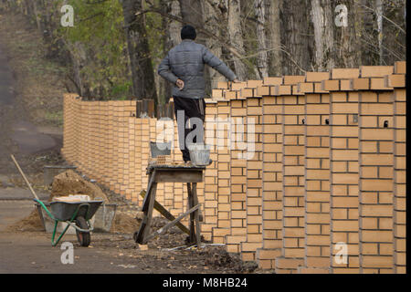 Mason checking wall is straight Stock Photo