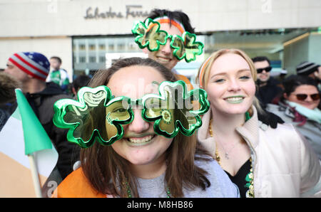 Revellers watch the St Patrick's Day parade in New York City. Stock Photo