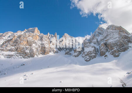 Phenomenal views of craggy mountain range, snowcapped peaks of the Dolomites. Sheer rocky walls, deep snow covering the valleys below. Italy, Alps.