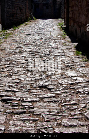 Narrow mediterranean street covered by stone on Solta island in Croatia