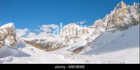Phenomenal views of craggy mountain range, snowcapped peaks of the Dolomites. Sheer rocky walls, deep snow covering the valleys below. Italy, Alps.