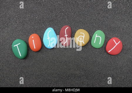 Tiffany, feminine given name with multicolored painted stones over black volcanic sand Stock Photo