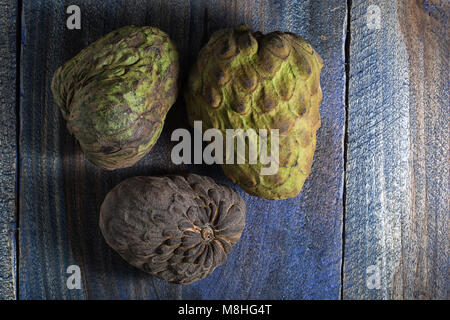 cherimoya fruits also known as custard apple on rustic background Stock Photo