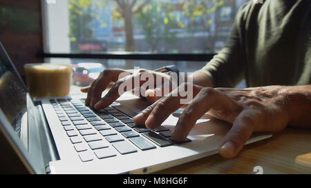 Critic uses laptop for work.  Stock Photo
