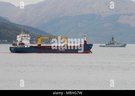 R.E.S. Chartering's general cargo ship Naja, passing Gourock on the Firth of Clyde, with the Royal Navy patrol boat HMS Severn (P282) in the distance. Stock Photo