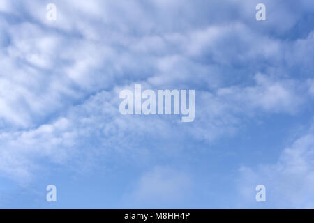 High white wispy cirrus clouds with cirro-stratus in the blue Australian sky sometimes called mare's tails indicate fine weather now but stormy change Stock Photo