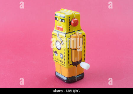 Little mechanical yellow toy robot Stock Photo