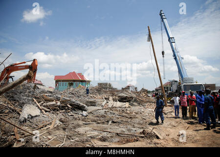 Bujumbura, Burundi. 17th Mar, 2018. People stand next to debris of a collapsed building in Bujumbura, Burundi, on March 17, 2018. At least three bodies were recovered from debris on Friday after a three-story building collapsed on construction agents in Bujumbura, the police said. Credit: Evrard Ngendakumana/Xinhua/Alamy Live News Stock Photo