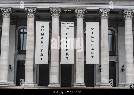 Munich, Bavaria, Germany. 17th Mar, 2018. The Residenz Theatre hangs banners reading ''Humanity, Respect, diversity''. Protesting against the arrival of Pegida Dresden's Lutz Bachmann and Sigfried Daebritz in Munich, no less than three demonstrations were organized by the city, including a Muenchen ist Bunt and Bellevue di Monaco protest at Max Joseph Platz. At this demonstration, choirs were in attendance, along with celebrities, politicians, and other prominent Muenchners dressed as doctors in order to tell Pegida that they will help them go back to Dresden. Participants: Syrischer Fri