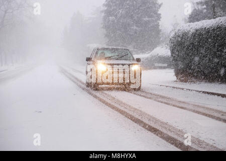 Hereford, Herefordshire, UK - Sunday 18th March 2018 - Hereford city heavy snowfall overnight continues during Sunday morning in Hereford city - a 4WD car struggles on Aylestone Hill with the snowfall. Steven May /Alamy Live News