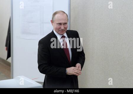 Moscow. 18th Mar, 2018. Russian President Vladimir Putin leaves a polling station after voting in Moscow March 18, 2018. Russia held presidential election on Sunday. Credit: Bai Xueqi/Xinhua/Alamy Live News Stock Photo