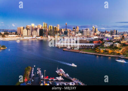 Dark sunset in Sydney city CBD from elevated point of view towards modern urban towers of Barangaroo on Darling harbour waterfront. Stock Photo