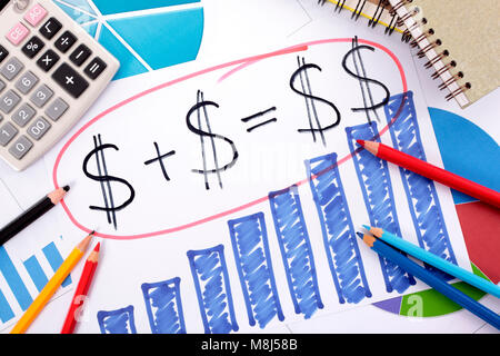 Simple savings or retirement formula written on a hand drawn bar chart surrounded by calculator, books and pencils. Stock Photo