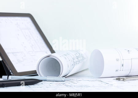 architectural projects, blueprints, drawing compass, pencil and tablet computer with stylus on desk Stock Photo