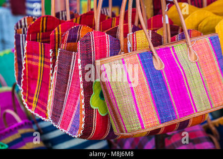 Colorful striped straw shopping bags in different sizes Stock Photo