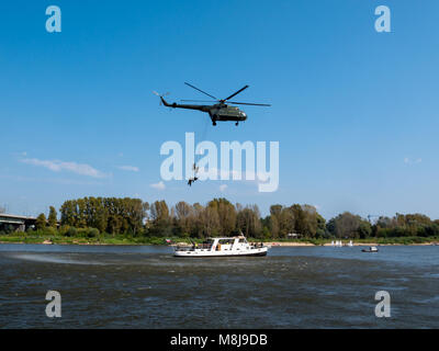 WARSAW, POLAND - SEPTEMBER 13, 2014: Polish GROM Special Forces show boarding a boat with terrorists from a helicopter. Stock Photo