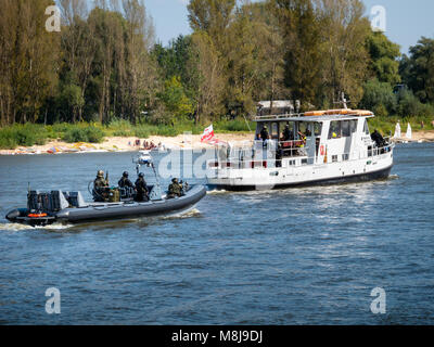 GROM Special Forces preparing for boarding a boat with terrorists from pontoons on the Vistula River. WARSAW, POLAND - SEPTEMBER 13, 2014 Stock Photo