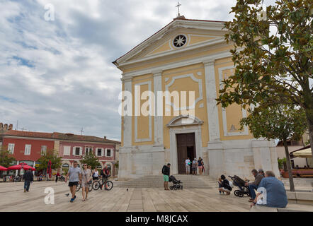 POREC, CROATIA - SEPTEMBER 21, 2017: People visit Church of Our Lady of Angels on Freedom Square. Porec is a town almost 2,000 years old and municipal Stock Photo