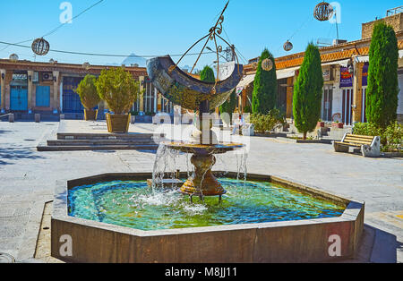 ISFAHAN, IRAN - OCTOBER 20,2017: The fountain with beautiful sundial decorates the Julfa square, located in Armenian neighborhood, on October 20 in Is Stock Photo