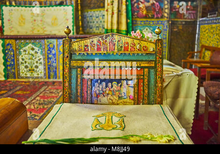 ISFAHAN, IRAN - OCTOBER 20,2017: The medieval chair at the altar of Vank Cathedral is decorated with carved details and painted miniatures on religiou Stock Photo