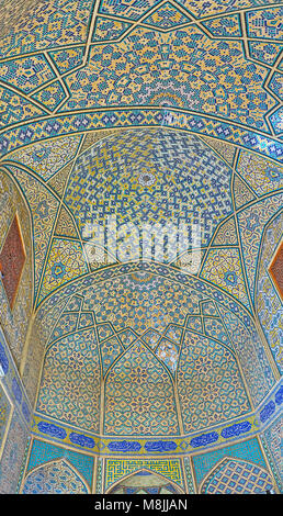 ISFAHAN, IRAN - OCTOBER 20, 2017: The great decors of the side portal of Chaharbagh madraseh - dome and walls are covered with compex geometric and st Stock Photo