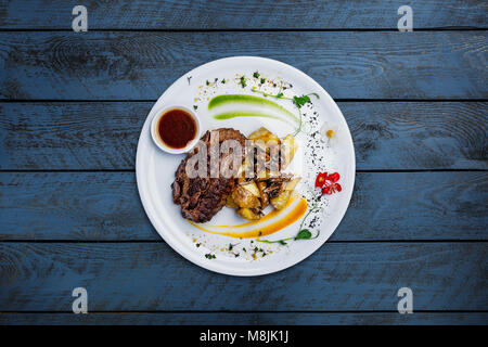 Horsemeat steak with potatoes and mushrooms. Stock Photo