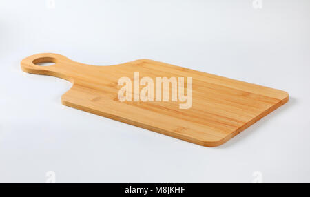 wooden cutting board with handle on white background Stock Photo