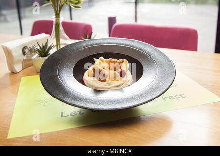 cheesecake in plate whit strawberries,crispy bananas  and biscuits isolated on white background ,delicious cake served in the restaurant. Stock Photo