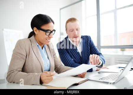 Two colleagues discussing new project together at office Stock Photo