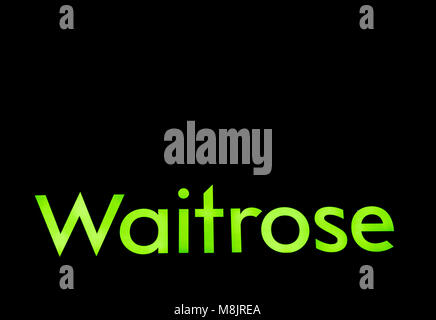 A fluorescent green Waitrose sign on the facade of one of the Supermarket chains stores with copy space. Stock Photo