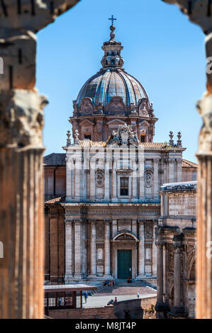 View of Santi Luca e Martina church at Palatine Hill framed by columns focused on the entrance facade dome steps and spire Stock Photo