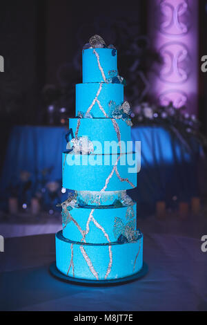 Stylish blue-green wedding cake from seven levels Stock Photo