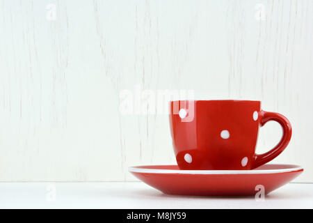 Red spotty mug on white background Stock Photo