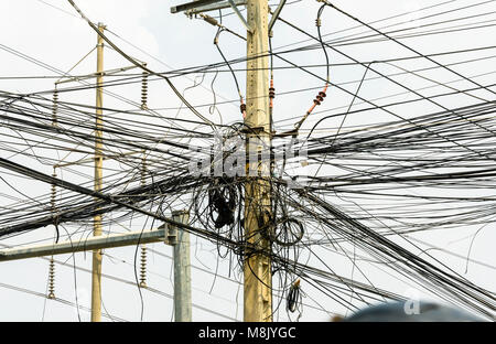Messy tangle of electricity cables wires on an electricity supply pole, Phnom Penh, Cambodia Stock Photo