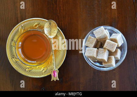 Turkish teacup and sugar cubes on wooden table Stock Photo