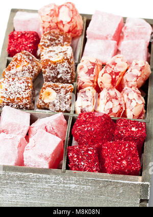 Assortment  turkish delight in wooden box isolated on white Stock Photo