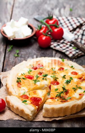 Cherry  tomatoes and cheese tart on wooden background Stock Photo