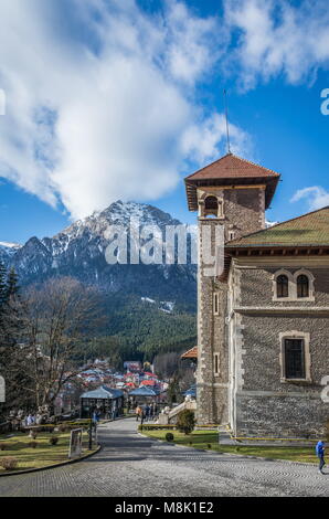 Cantacuzino Castle and the Carpathian Mountains in a sunny day. Residence and museum in a Transylvanian Busteni city, Romania Stock Photo