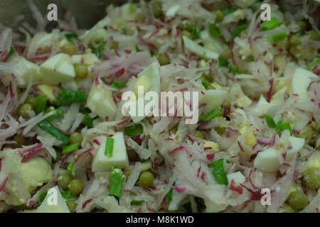 healthy vegan food. watermelon radish, cucumber and radish salad on white plate. top view Stock Photo