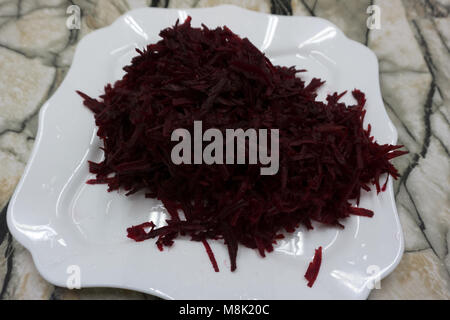 grated beets on a white background beetroot red Stock Photo