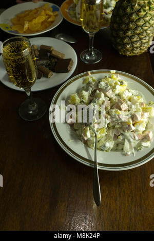 Christmas table dinner time with roasted meats decorated in Christmas style with glasses champagne. Background thanksgiving. The concept of a family h Stock Photo