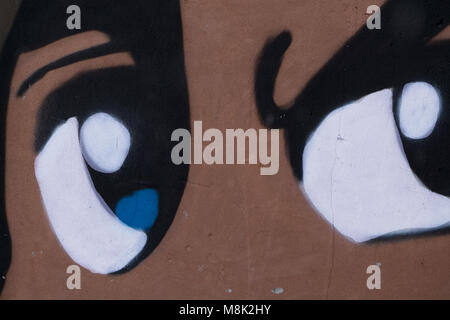 Colorful graffiti in an alley in the city centre within the walls . Stock Photo