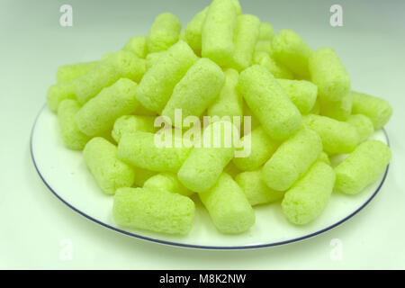 Sweet crunchy corn sticks or snacks isolated on white background Stock Photo