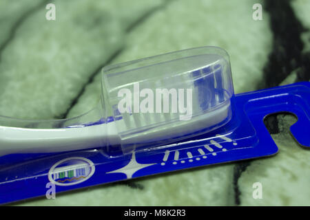 Toothbrushes in glass on blurred background Stock Photo