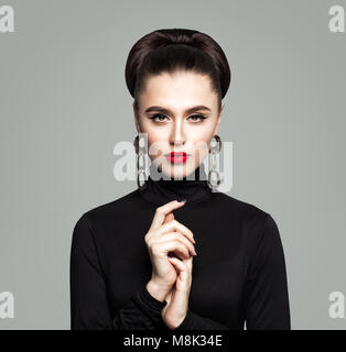 Fashion Portrait of Elegant Woman. Girl with Makeup, Manicure and Hair Updo. Cute Model in Black Clothes Stock Photo