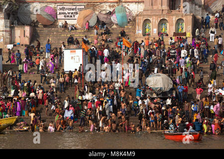 VARANASI, INDIA. February 28, 2017: Crowds of people the stairs of the embankment of the river Ganges, Varanasi, India. Hindus brush their teeth washe Stock Photo